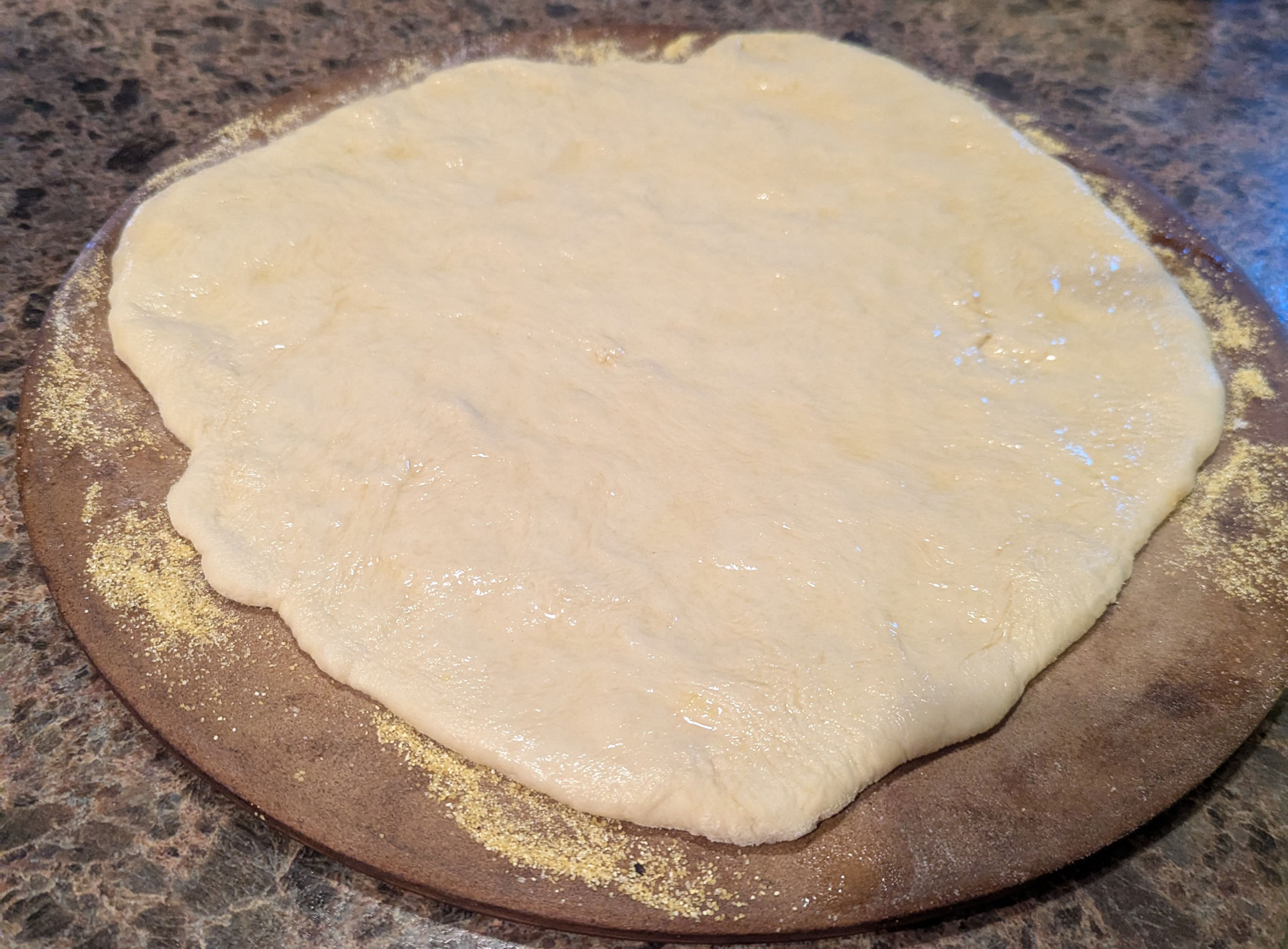 The dough rolled out on a pizza stone