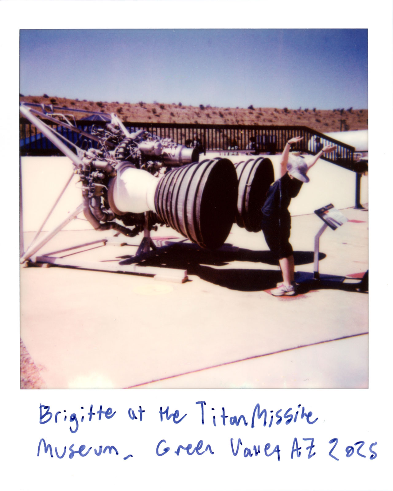 Brigitte standing in front of a missile engine at the Titan Missile Museum
